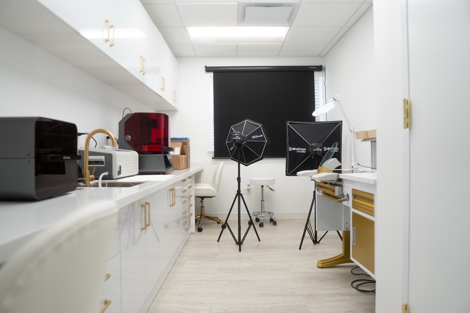 A room at the Alexandria office with a 3D printer and a photography setup for recording smiles