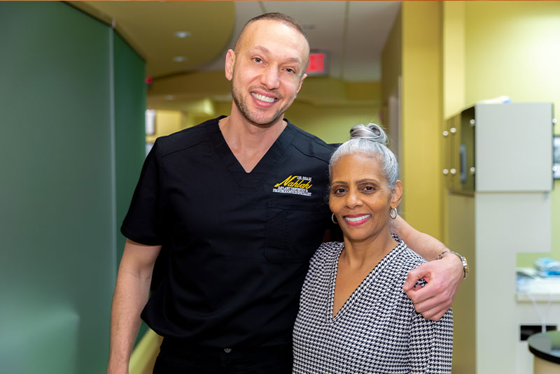 Dr. Nahlah with Yolanda, a full-arch patient of the practice